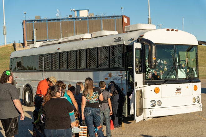 Community members wait to tour TransCor America’s prison transportation bus.