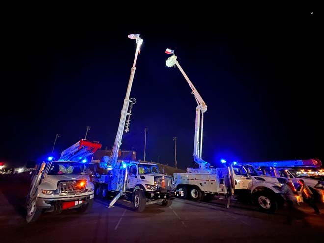 AEP utility trucks with flags aloft.