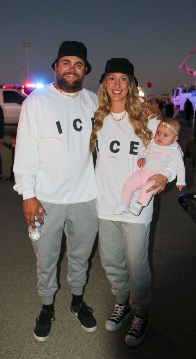 Lineman Newt Kitchens and his wife, Kasey, with their daughter.